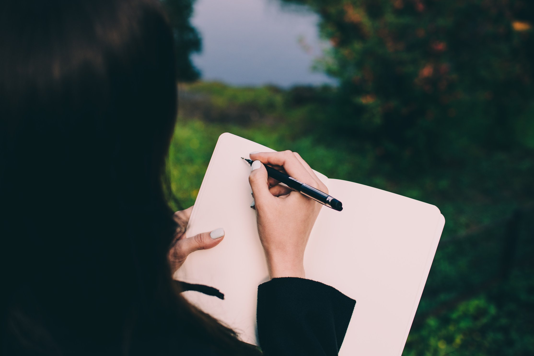 Girl Writing down Her Thoughts in a Notebook